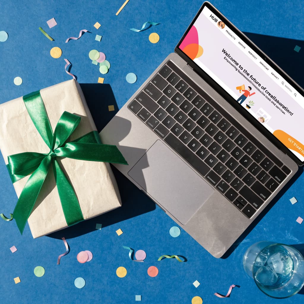 Gift box next to a laptop showing a new website homepage