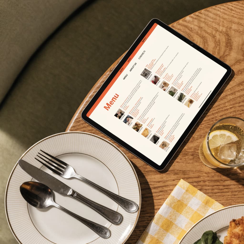 Restaurant table with a tablet showing a menu website